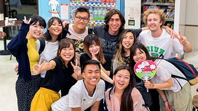 Students gather with locals in a Japanese store. 